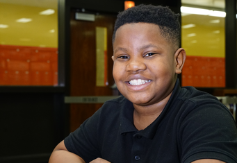 Smiling male student at GreenTree Preparatory Academy in Milwaukee.